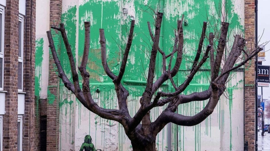 Banksy's latest artwork of green painted behind a tree to signify leaves