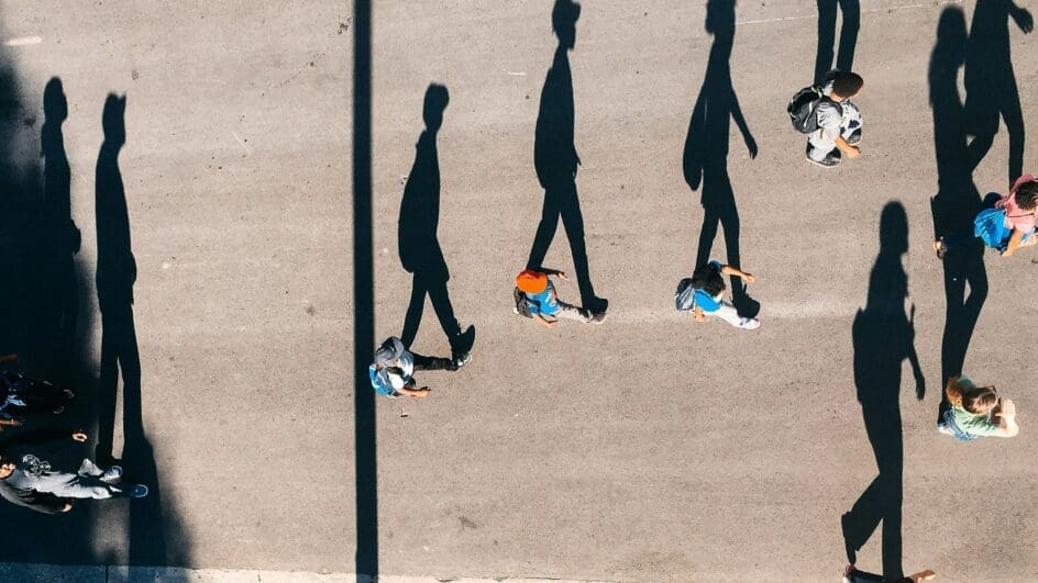 People walking with their shadows clearly visible