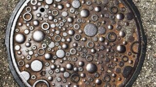 Manhole cover decorated with blobs and circles