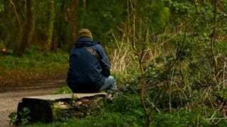 man sitting in park on a bench