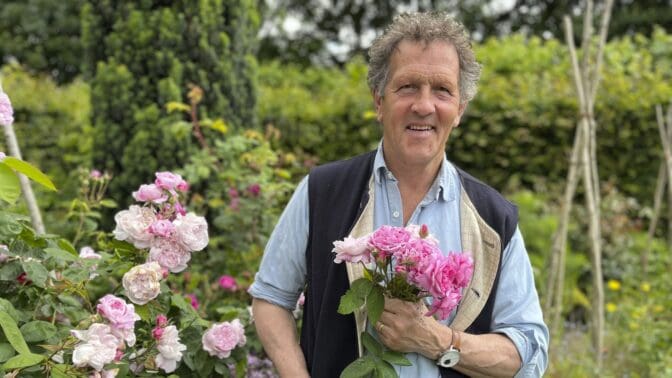 Monty Don in his garden at Longmeadow holding roses cut from the garden