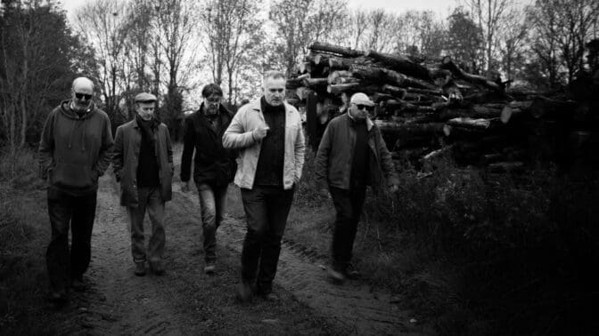 Photo of the six band members of the newly formed 'The Lokeys' fronted by garden designer Matthew Wilson, walking through a building site ...