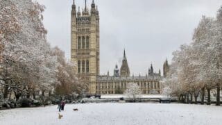 Image of Victoria Tower Gardens in London, facing Parliament buildings in the snow.