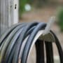 Garden hose pipe rolled up on a stand