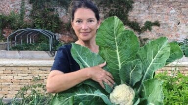 Rachel de Thame with a cauliflower in her garden