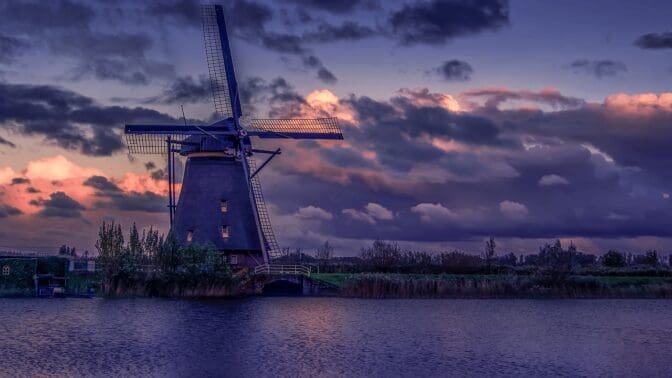 netherlands, dutch windmill by a river