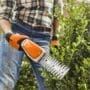 Stihl HSA 26 trimmers being used on a box hedge